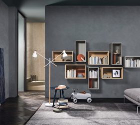 salotto minimal con pareti grigie con poltrona e scaffali a forma rettangolare appese a muro
